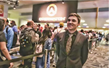  ?? — Photos for The Washington Post by Noah Smith ?? Pro Gamer Jake Lyon, of the Overwatch League’s Houston Outlaws, stands outside Overwatch Arena at Blizzcon, where he was commentati­ng on matches and interactin­g with fans.