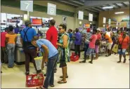  ?? CHRIS BRANDIS — THE ASSOCIATED PRESS ?? Residents stand in line at a grocery store Monday as they prepare for the arrival of Tropical Storm Dorian, in Bridgetown, Barbados.