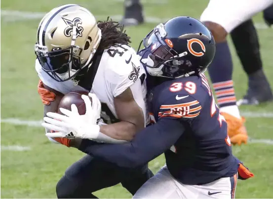  ?? GETTY IMAGES ?? Bears safety Eddie Jackson, trying to bring down Saints running back Alvin Kamara, missed practice Wednesday with a knee injury he suffered against the Rams.