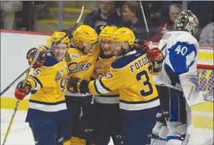  ?? The Canadian Press ?? Erie Otters defenceman Darren Raddysh, second from right, celebrates his goal with Aidan Timmermans, left, Dylan Strome and Warren Foegele, right, in front of Saint John Sea Dogs goaltender Callum Booth during first-period semifinal action at the...