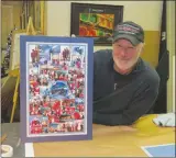  ?? Joseph B. Nadeau/The Call ?? Marc Morelle shows off a poster collage made from pictures taken of family and friends at the city’s Polar Express train ride.