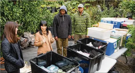  ?? ADAM ROSE/NETFLIX ?? Marie Kondo (second from left) works with Jimmy (second from right) and Logan (right), a father and son who own an organic plant and garden design business in California, in the first episode of her new Netflix show, “Sparking Joy.”