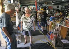  ?? Photos by Paul Chinn / The Chronicle ?? Left: Spanish Flat Country Store owner Marcia Ritz and fiance Jerry Rehmke discuss the shutoff at Lake Berryessa.
Below left: Elaine Medina and mother Lucy Medina make cold sandwiches for diners.