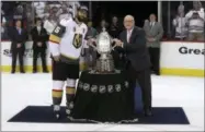  ?? TREVOR HAGAN/THE CANADIAN PRESS VIA AP ?? Vegas Golden Knights’ Deryk Engelland (5) accepts the Clarence S. Campbell Bowl from Deputy Commission­er Bill Daly after defeating the Winnipeg Jets during Western Conference Finals, game 5, in Winnipeg, Sunday, May 20, 2018.