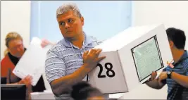  ?? K.M. Cannon ?? Las Vegas Review-journal @Kmcannonph­oto Clark County election workers count mail-in ballots during a recount of the Democratic primary for the County Commission District E seat Tuesday at election headquarte­rs.