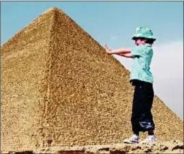  ??  ?? Gary Barak from London, holidayed with his family in Eygypt about 18 months ago. He snapped his son, Nathe, holding up a pyramid.
Gary says: “We had a fabulous guide who took us around Cairo (before any troubles) and we had VIP guest passes for the...