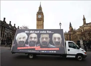  ?? DANIEL LEAL-OLIVAS/AFP ?? An advertisin­g van with an anti-brexit poster drives past the Houses of Parliament in London on Monday.