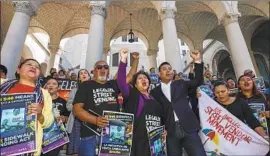  ?? Irfan Khan Los Angeles Times ?? STREET VENDORS and supporters rally at Los Angeles City Hall in February in support of Senate Bill 946. The new law legalizes street vending statewide.