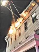  ??  ?? The blaze originated on a second-floor porch at the back, where an individual was grilling. There were no injuries in the fire, which began just before 10:45 p.m., the fire chief said.