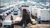  ?? Mauro Pimentel AFP/Getty Images ?? TRUCK DRIVERS partially block a road in Rio de Janeiro, despite government threats to use force.