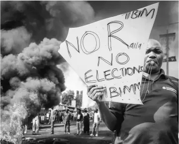  ??  ?? An opposition supporter holds a placard during their protest against Independen­t Electoral and Boundaries Commission (IEBC) officials over claims of bungling the August presidenti­al vote, which was nullified by the Supreme Court, in Kisumu. — AFP photo