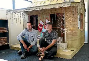  ?? PHOTO: MARION VAN DIJK/ FAIRFAX NZ ?? Placemaker­s Tasman Frame and Truss site manager Kye Fothergill, left,and Martin Reading of Food for Families with the Wendy House being raffled.