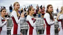  ?? CONTRIBUTE­D PHOTOS BY ANDRES LEIVA ?? Palm Beach Central student Ashley Jacob (center) stands among cheer teammates during the playing of the national anthem before the start of the football game.