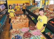  ?? SAEED KHAN / AGENCE FRANCE-PRESSE ?? Volunteers wait for customers at OzHarvest Market, a recycled food supermarke­t, in Sydney, Australia.