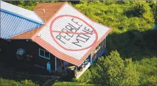  ?? Richard Read Los Angeles Times ?? A ROOFTOP message to the corporatio­n that hopes to mine copper in southwest Alaska.