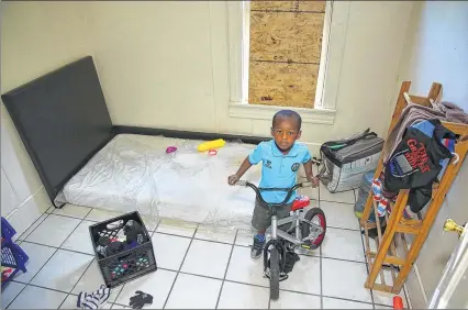  ??  ?? April Williams’ son Solomon Blunt, 4, shows off his bike in his room on N. 39th St.