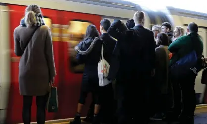  ??  ?? ‘Stand clear of the bores.’ Commuters await a London Undergroun­d train. Photograph: Kevin Coombs/Reuters