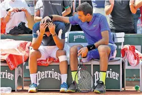  ??  ?? Down and out: Juan Martín del Potro comforts his stricken rival, Nicolás Almagro