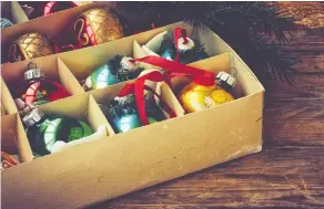  ??  ?? Ornaments can be wrapped and stored in sturdy boxes to keep them safe for the next holiday season. Garland can be wrapped around a cardboard tube to keep it from getting tangled.