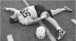  ?? POSTMEDIA NEWS FILES ?? B.C. Lions’ Matt Norman goes through his stretching during a practice Monday. Norman has been taking snaps at centre.