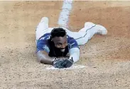  ?? Tom Pennington, Getty Images ?? Tampa Bay’s Randy Arozarenas smiles after sliding into home during the ninth inning to score the game winning run against the Los Angeles Dodgers on Saturday.