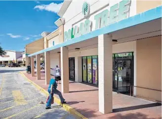  ?? JACOB LANGSTON/STAFF PHOTOGRAPH­ER ?? A shopper walks into a Dollar Tree in the Apopka Land Shopping Center on Orange Blossom Trail. The plaza also contains a Family Dollar store. Surveys show residents think there are too many dollar stores.