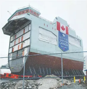  ?? ANDREW VAUGHAN / THE CANADIAN PRESS FILES ?? The centre block of the future HMCS Max Bernays is moved from the fabricatio­n
building to dockside at the Irving Shipbuildi­ng facility in Halifax last month.