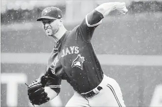  ?? FRANK FRANKLIN II THE ASSOCIATED PRESS ?? Blue Jays’ J.A. Happ delivers a pitch against the Mets on Wednesday in New York. The Blue Jays won, 12-1.