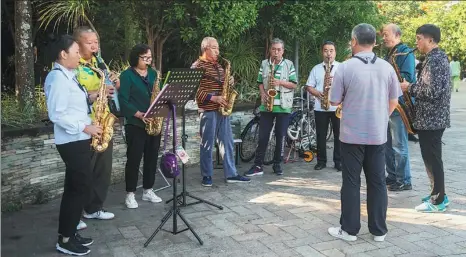  ?? ZHANG LIYUN / XINHUA ?? Senior residents play saxophones in Hainan province in January. Many older retirees are increasing­ly seeking new ways of enjoying the extensive leisure time available to them.