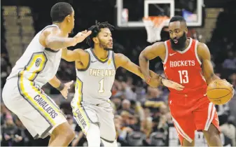  ?? Tony Dejak / Associated Press ?? The Rockets’ James Harden (right) drives past the Cavaliers’ Channing Frye (left) and Derrick Rose. Harden finished with a modest 16 points as Houston humiliated Cleveland at home.