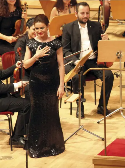  ?? AP Photo; AFP ?? Racha Rizk with the Syrian Expat Philharmon­ic Orchestra in Berlin, left. Far left, Lebanese singer Ghada Shbeir will also perform in Sharjah