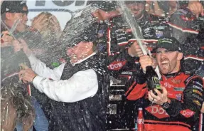  ??  ?? Austin Dillon celebrates with his team after winning the Daytona 500 in which he led one lap of the race. JASEN VINLOVE/USA TODAY SPORTS