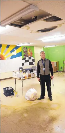  ?? GREG SORBER/JOURNAL ?? Paul Roney, Grant Middle School principal, shows classrooms that are no longer usable due to water damage. A leaking roof resulted in tile stains and holes in the ceiling.