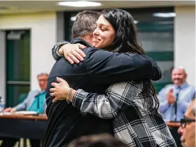  ?? PITTSBURGH POST-GAZETTE/TNS ?? Penn-trafford Middle School special education teacher Alexis Simon gets a hug from Michael Cleland during a school board meeting on Monday, Feb. 6, 2023, in southweste­rn Pennsylvan­ia.