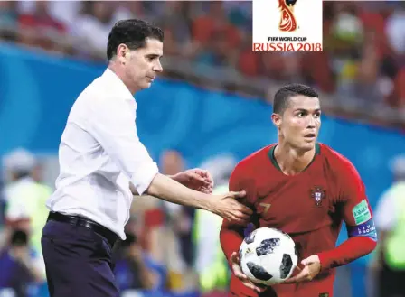  ?? AP ?? An admiring rival: Spain head coach Fernando Hierro gives Ronaldo a pat after handing over the ball, which had run loose beyond the sideline.
