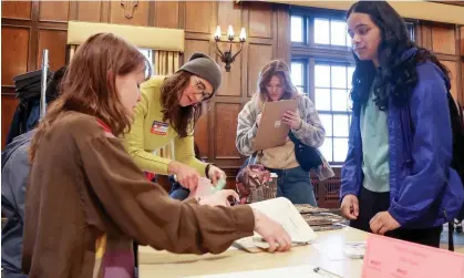  ?? Photograph: John Hart/ AP ?? From left, poll workers at UW-Madison, register student voters on the campus in Madison, Wisconsin, on 2 April.