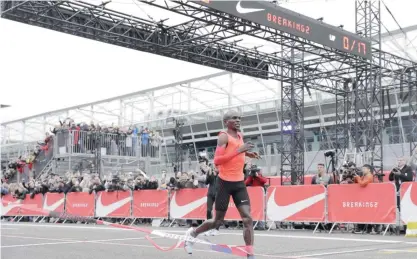  ??  ?? MONZA: Olympic marathon champion Eliud Kipchoge crosses the finish line of a marathon race at the Monza Formula One racetrack. — AP