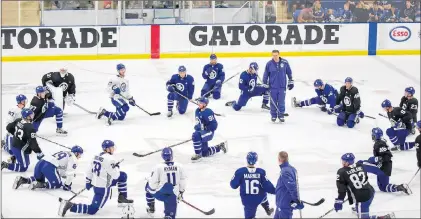  ?? CANADIAN PRESS PHOTO/AARON LYNETT ?? Toronto Maple Leafs forward John Tavares takes the centre of the circle as he and his teammates stretch following practice during Maple Leafs training camp in Niagara Falls, Ont., on Sunday. The majority of players on the season-opening roster of the ECHL expansion Newfoundla­nd Growlers will come from players who attended the Maple Leafs’ camp.