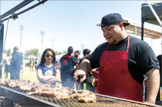  ??  ?? Chef Edgar Barraza cooking Carne Asada for the Don Romero BBQ booth during the 2018 Imperial Valley Carne Asada Cook-Off held Saturday afternoon at Stark Field in El Centro. VINCENT OSUNA PHOTO