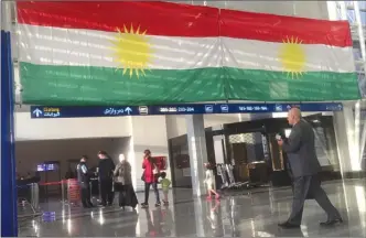  ?? The Associated Press ?? A Kurdish flag hangs in the Irbil Internatio­nal Airport, in Iraq. Iraq's prime minister ordered the country's Kurdish region to hand over control of its airports to federal authoritie­s.