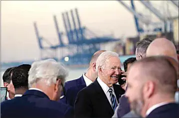  ?? SUSAN WALSH / AP ?? President Joe Biden talks on the phone after speaking during a visit at the Port of Baltimore on Wednesday.