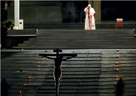  ?? AP ?? Pope Francis presides over the Via Crucis, or Way of the Cross, ceremony in St Peter’s Square empty of the faithful following Italy’s ban on gatherings to contain coronaviru­s contagion, at the Vatican.