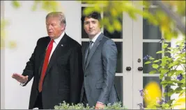  ?? Carolyn Kaster ?? The Associated Press President Donald Trump and Canadian Prime Minister Justin Trudeau walk Wednesday along the Colonnade to the Oval Office of the White House.