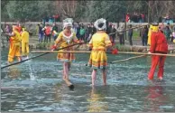  ??  ?? Some members of the Miao ethnic group in Guiyang, Guizhou province, perform bamboo drifting during a festival.