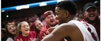  ?? NWA Democrat-Gazette/CHARLIE KAIJO ?? Arkansas guard Daryl Macon
celebrates with fans after the Razorbacks’ victory over Oklahoma State earlier this season in Fayettevil­le. Macon was named a first-team All-SEC selection by The Associated Press on Tuesday and was placed on the All-SEC...