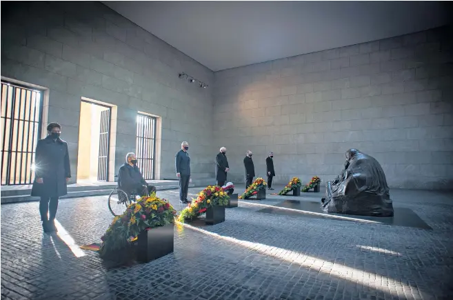  ??  ?? The Prince of Wales joins German dignitarie­s at the Neue Wache memorial in Berlin, which is dedicated to victims of war and tyranny. Below, the Prince with the Duchess of Cornwall