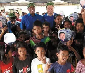  ?? ?? Choong with children of Kampung orang asli Kuala Woh during his campaign tour of Chenderian­g. With him is mic deputy president datuk Seri m. Saravanan who is incumbent mp for Tapah.