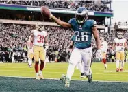  ?? Tim Nwachukwu / Getty Images ?? The Eagles’ Miles Sanders (26) scores on a 13-yard touchdown run against the 49ers in the second quarter of the NFC Championsh­ip game on Sunday.