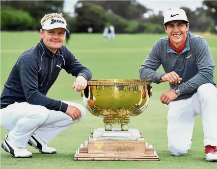  ??  ?? It’s ours: Denmark’s Soren Kjeldsen (left) and Thorbjorn Olesen posing with their trophy after winning the World Cup of Golf at Kingston Heath in Melbourne yesterday. — AP