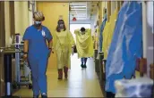  ?? JULIE BENNETT — THE ASSOCIATED PRESS ?? Nurses and other medical staff make their way through the seventh floor COVID-19 unit at East Alabama Medical Center in Opelika, Ala., on Dec. 10. COVID-19 patients occupy most of the beds in ICU in addition to the noncritica­l patients on the seventh floor.